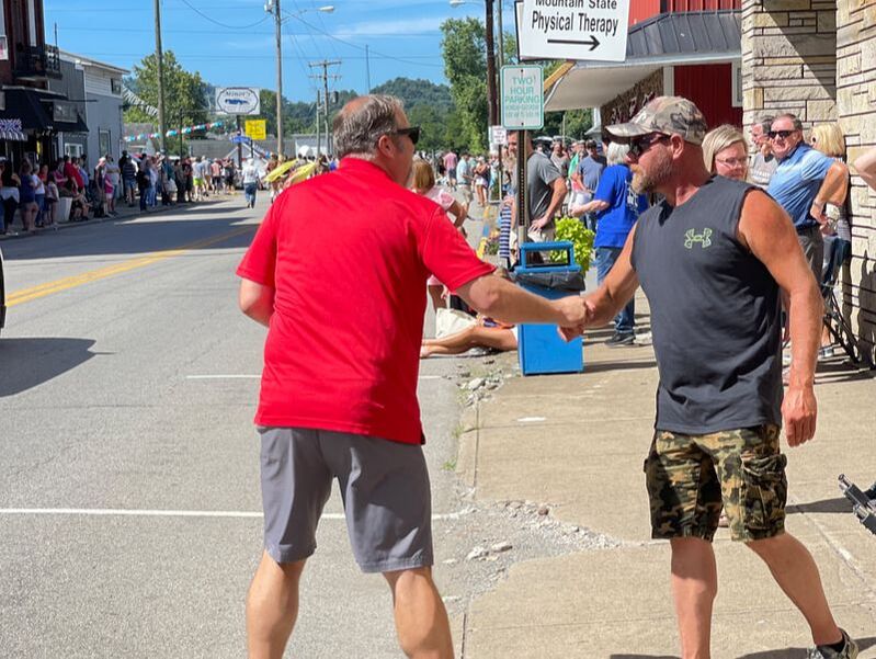 Picture of Delegate Riley shaking hands with a Parade spectator in downtown Shinnston WV