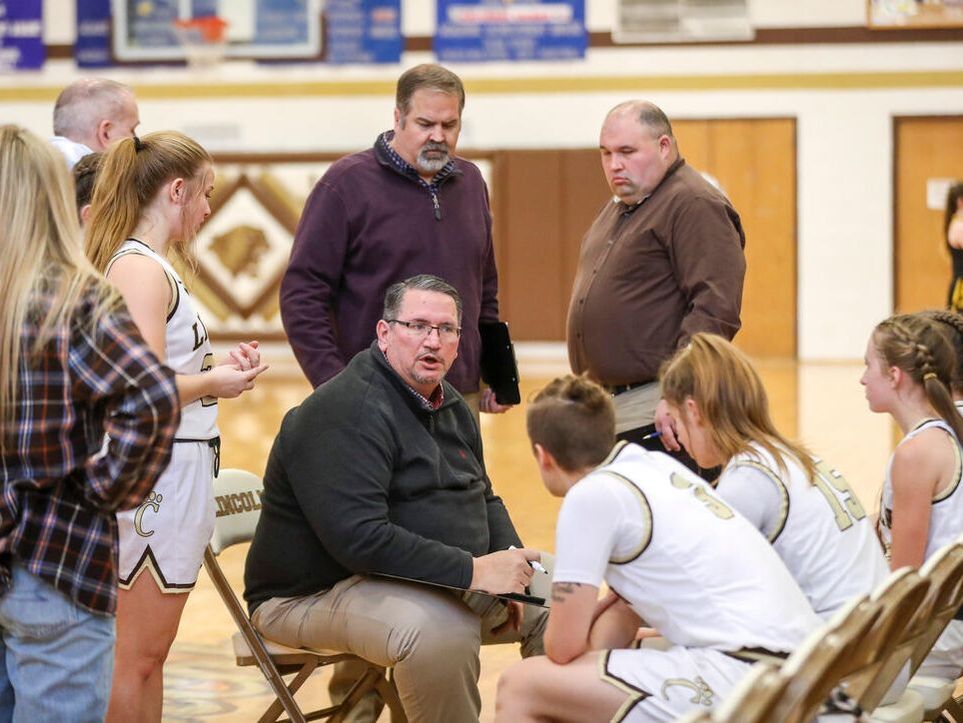 Picture of Clay Riley coaching Lincoln GIrls Basketball Players with Rob Hawkins and MudCat